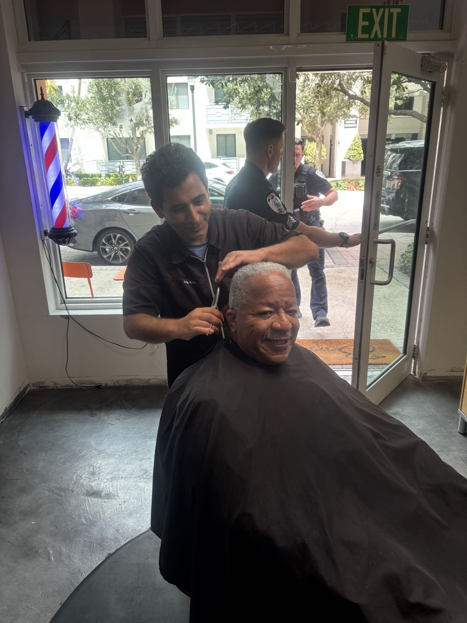 Robby cutting the hair of West Palm Beach Mayor Keith James